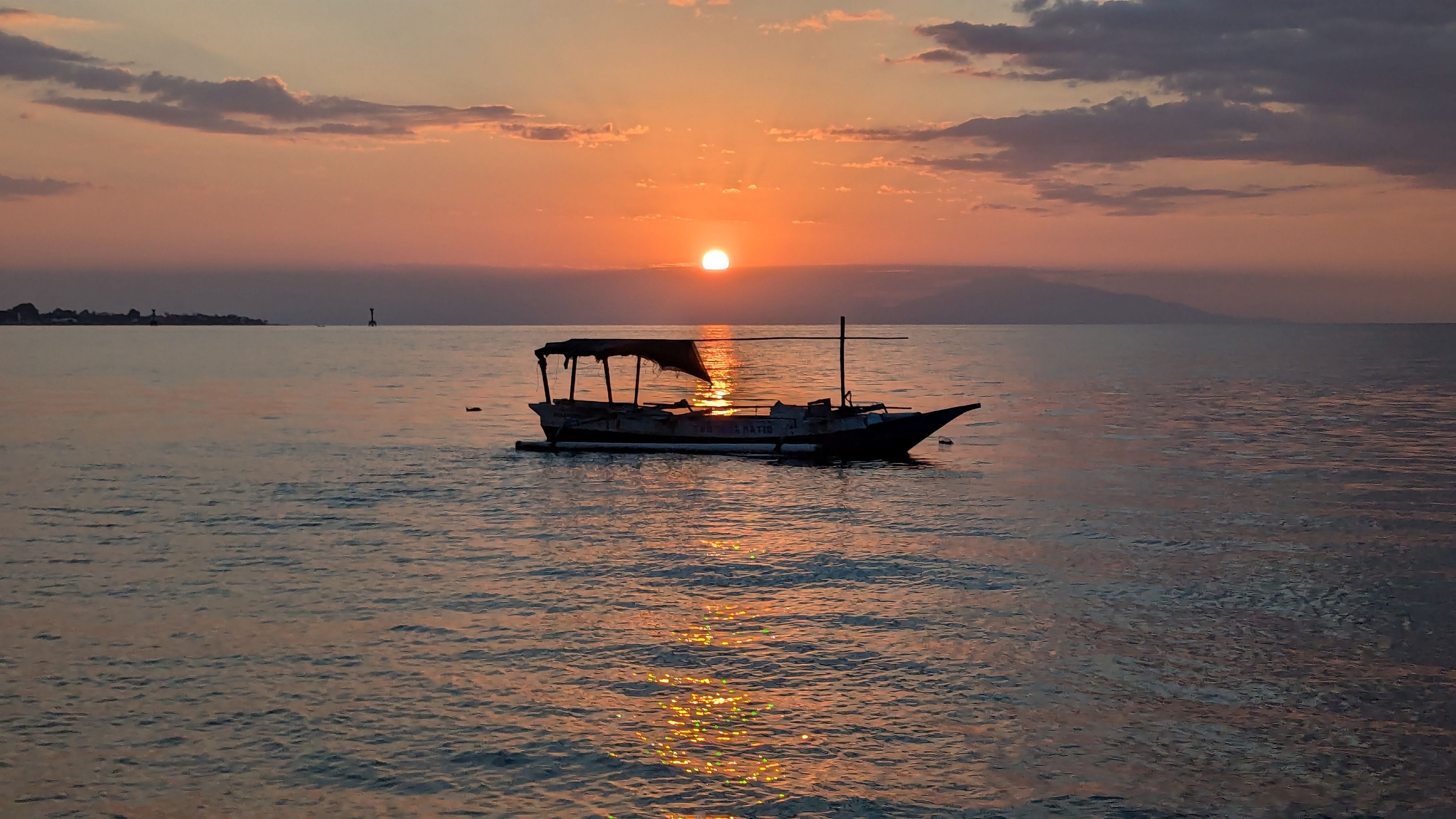 dili beach boat and sunset